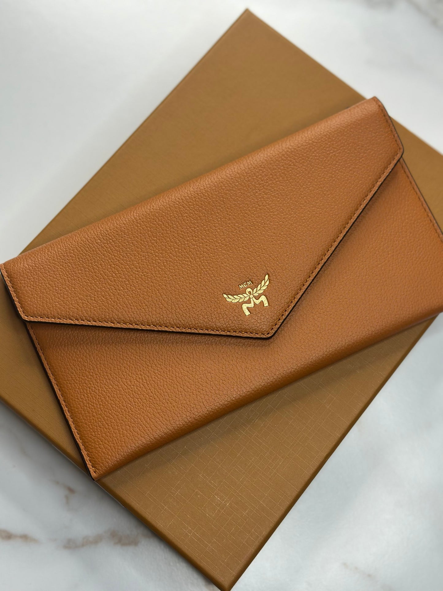 Pre-Owned MCM Himmel Continental Pouch in embossed cognac leather