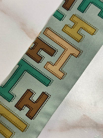 Pre-owned HERMÈS TWILLY IN LIGHT GREEN SILK WITH AN H PRINT