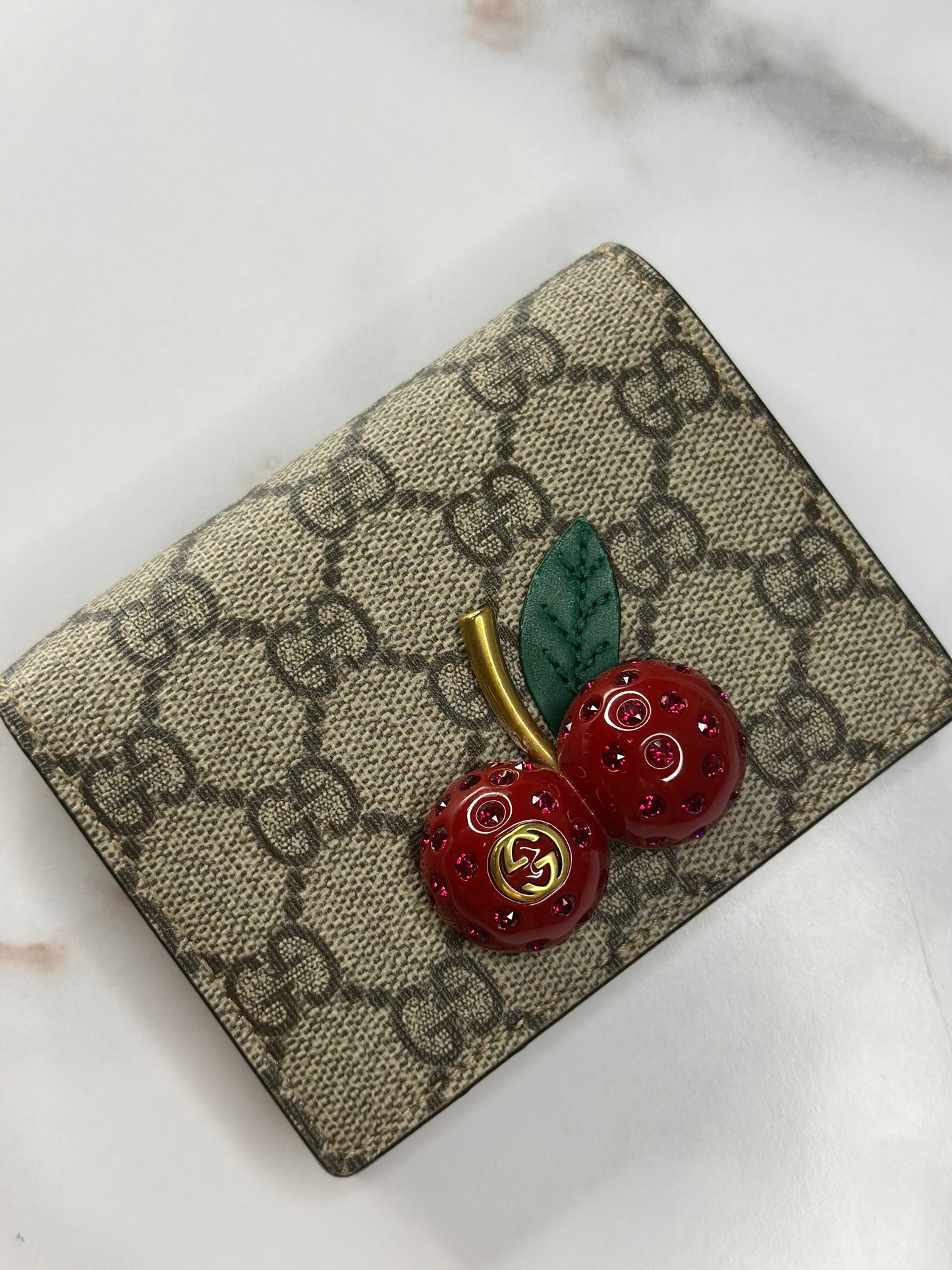 Pre-owned Gucci GG Supreme canvas bifold or compact wallet with a cherry embellishment.