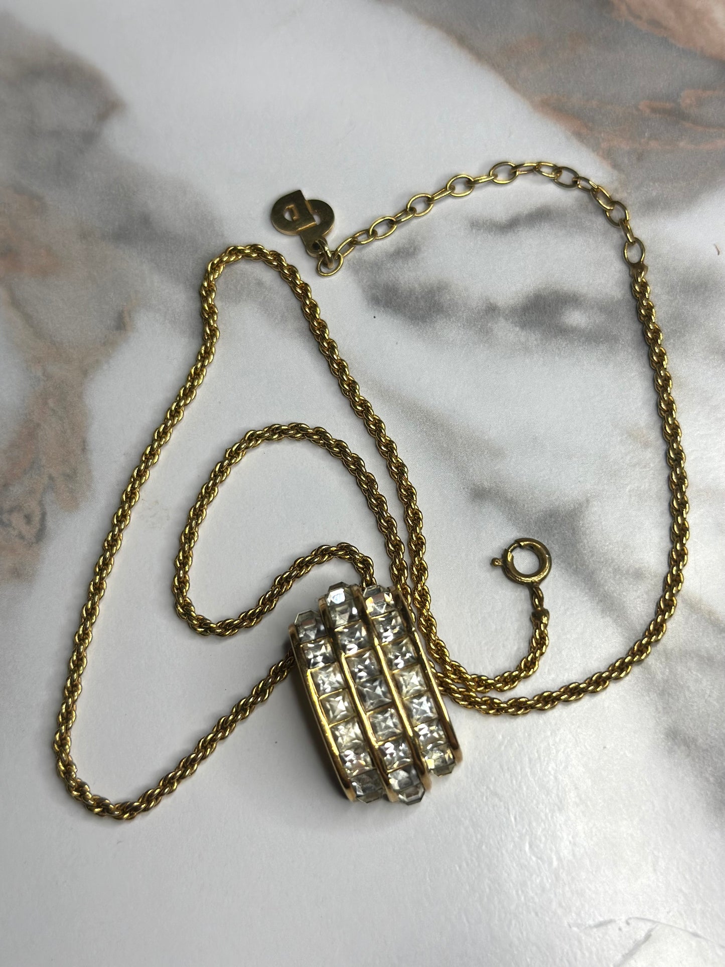 Pre-owned Christian Dior vintage necklace features a gold-tone chain and a cylindrical pendant
