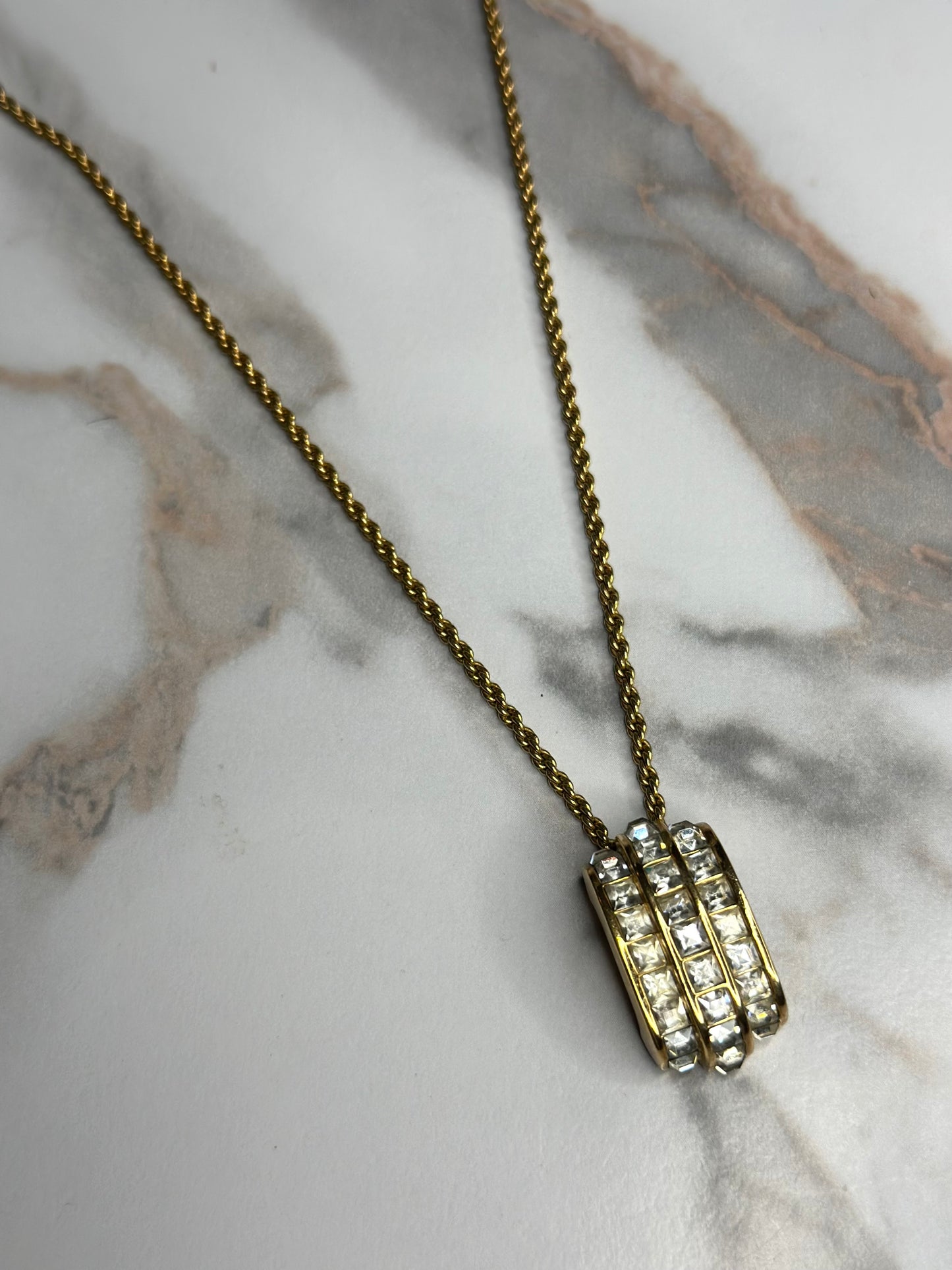 Pre-owned Christian Dior vintage necklace features a gold-tone chain and a cylindrical pendant