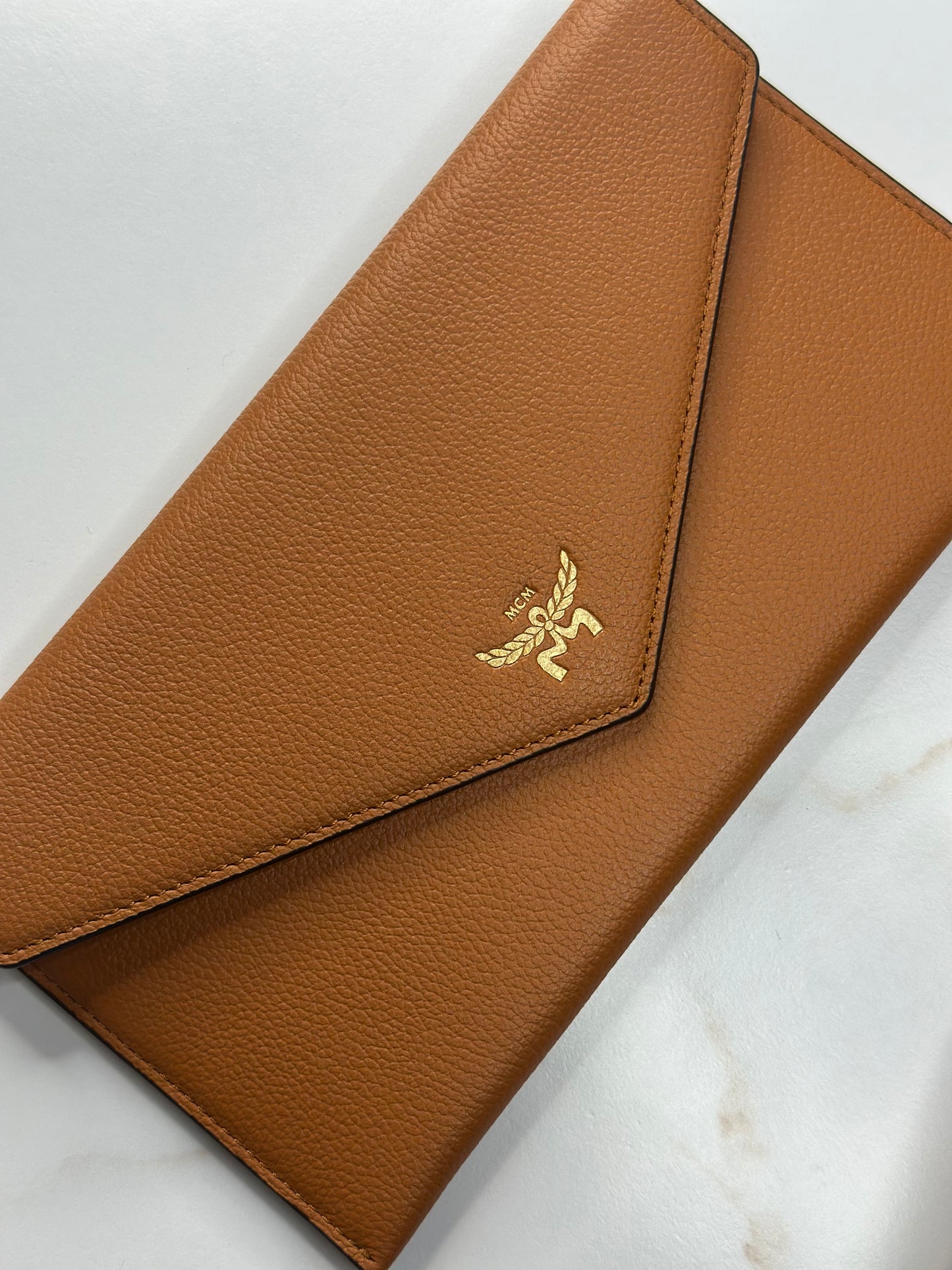 Pre-Owned MCM Himmel Continental Pouch in embossed cognac leather