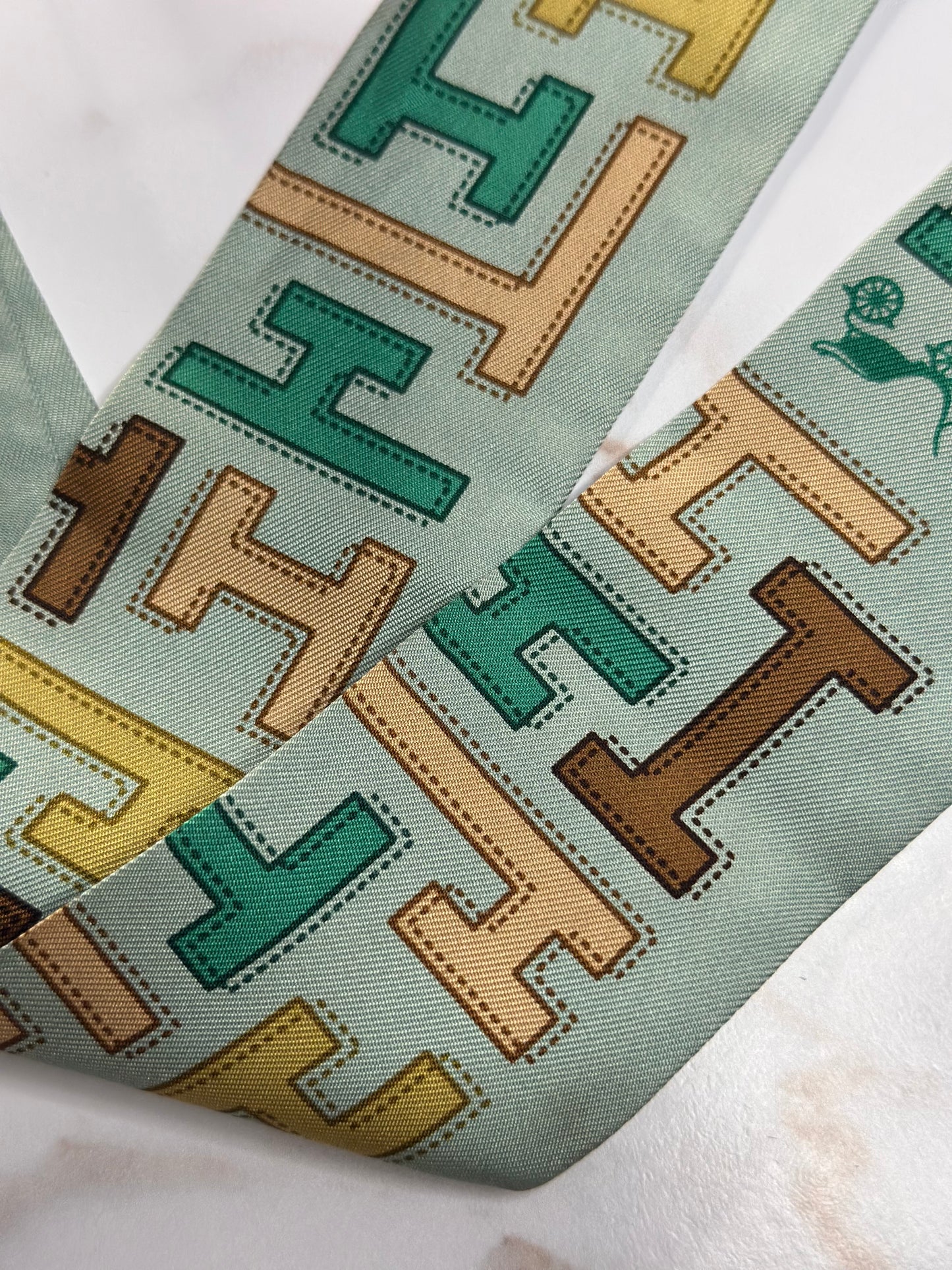 Pre-owned HERMÈS TWILLY IN LIGHT GREEN SILK WITH AN H PRINT