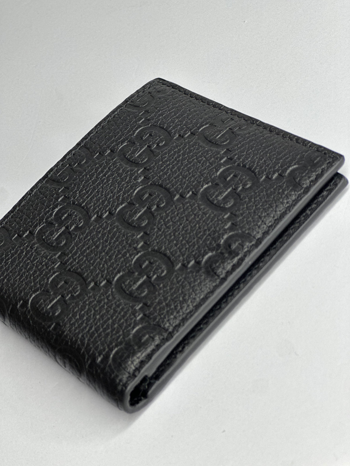 Pre-owned Gucci GG embossed black leather bifold wallet