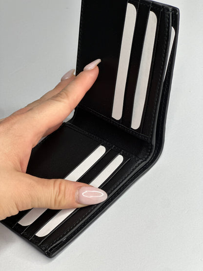 Pre-owned Gucci GG embossed black leather bifold wallet