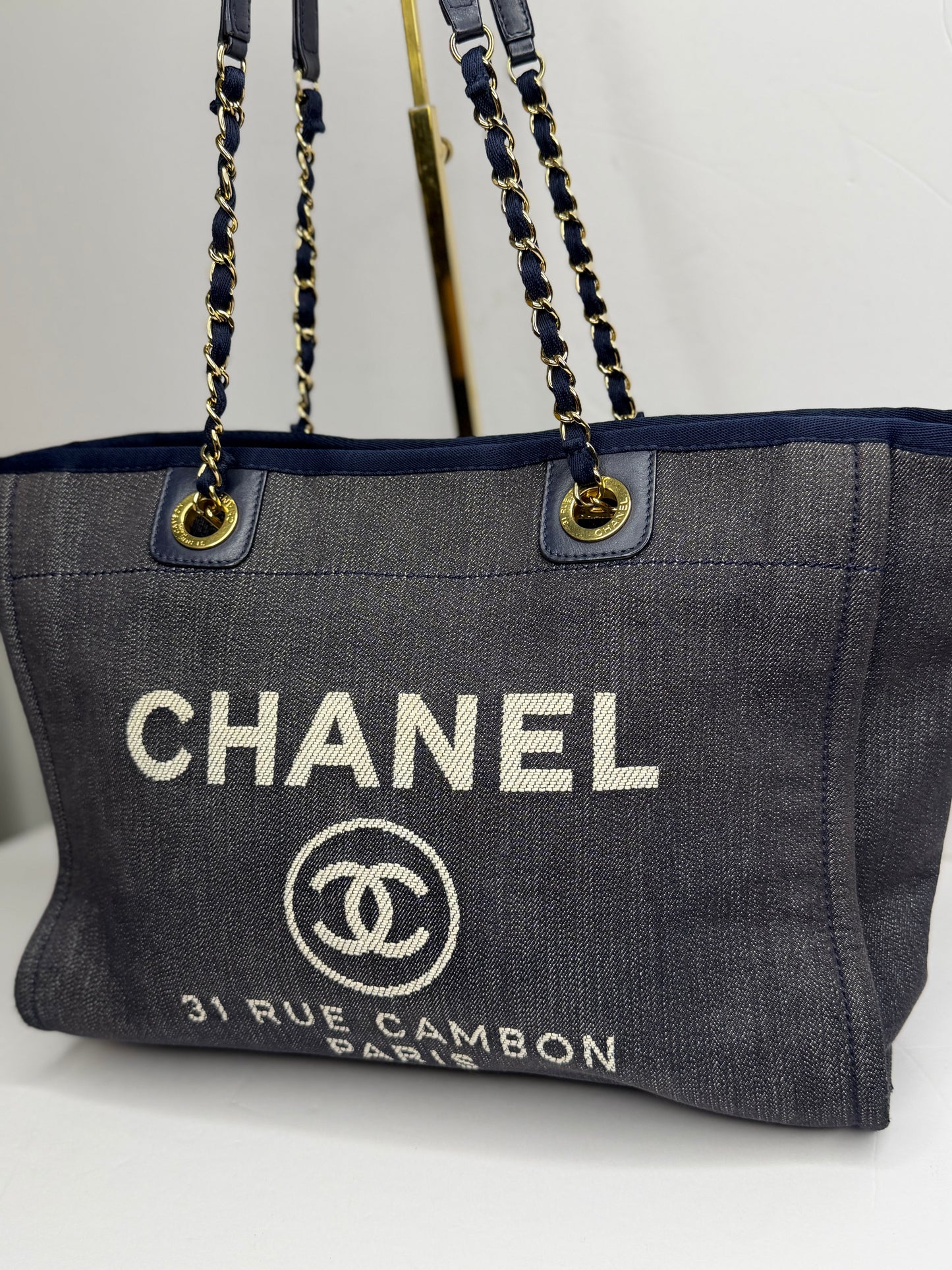 Pre-owned Chanel Deauville tote bag crafted in blue denim with gold-tone hardware medium tote