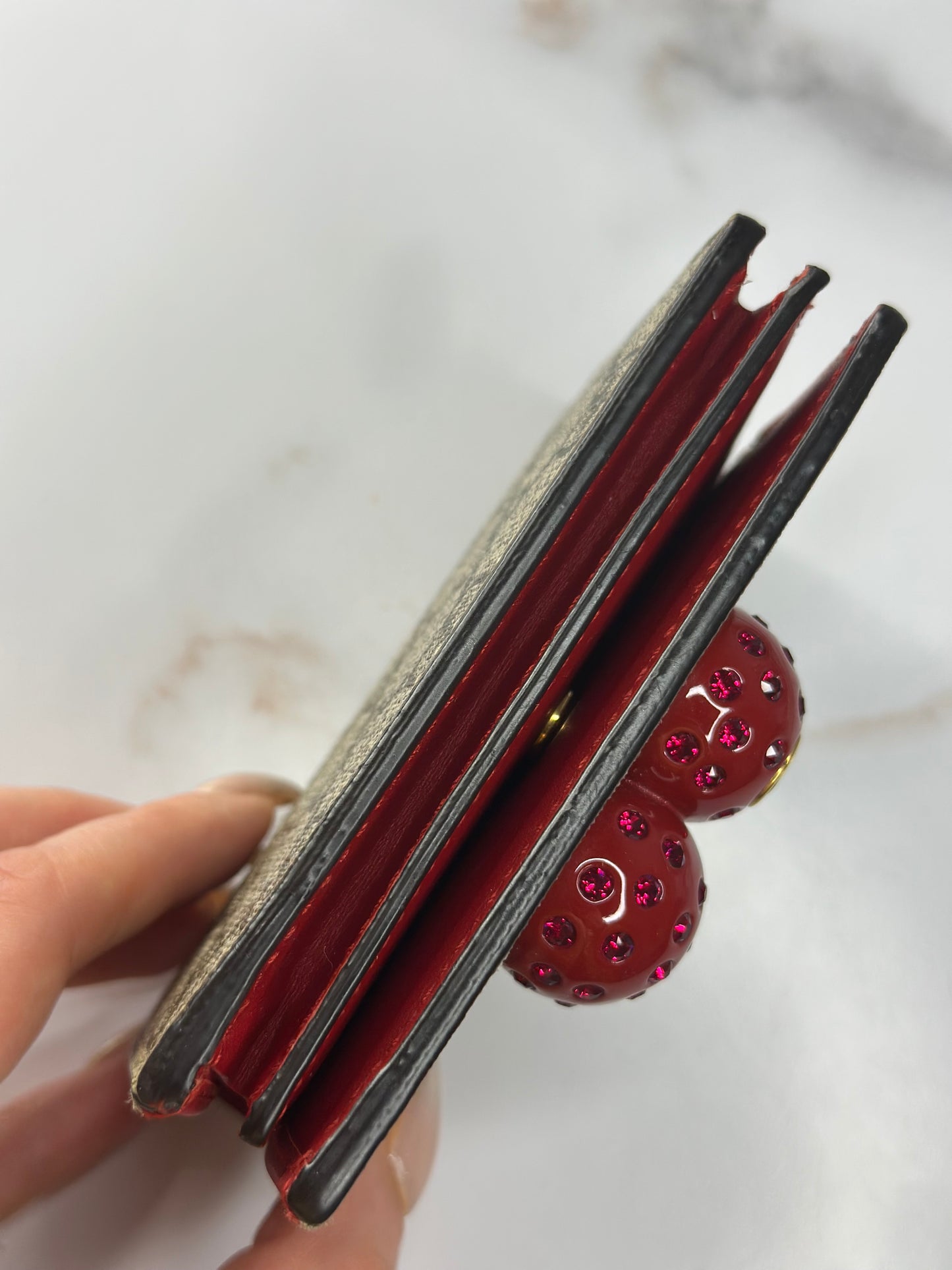 Pre-owned Gucci GG Supreme canvas bifold or compact wallet with a cherry embellishment.