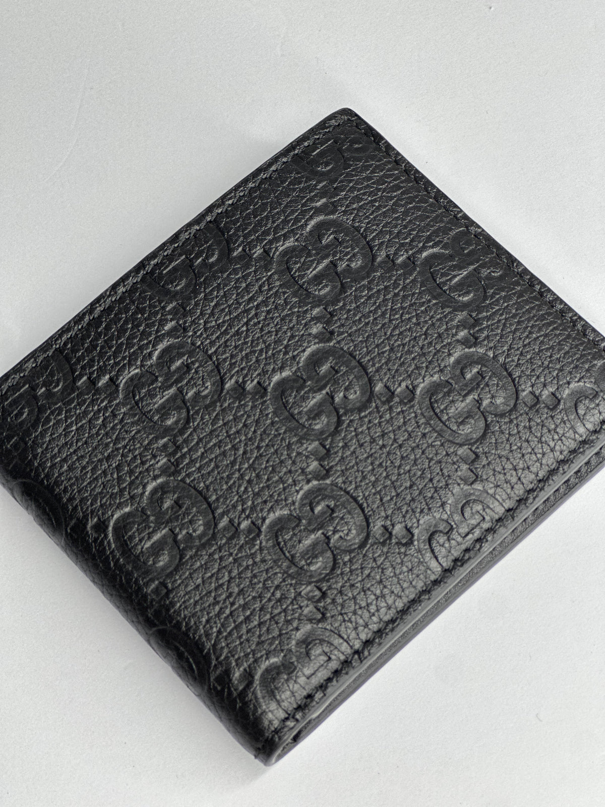 Pre-owned Gucci GG embossed black leather bifold wallet