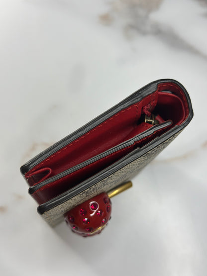 Pre-owned Gucci GG Supreme canvas bifold or compact wallet with a cherry embellishment.